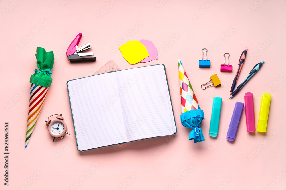 Colorful school cones and stationery on pink background