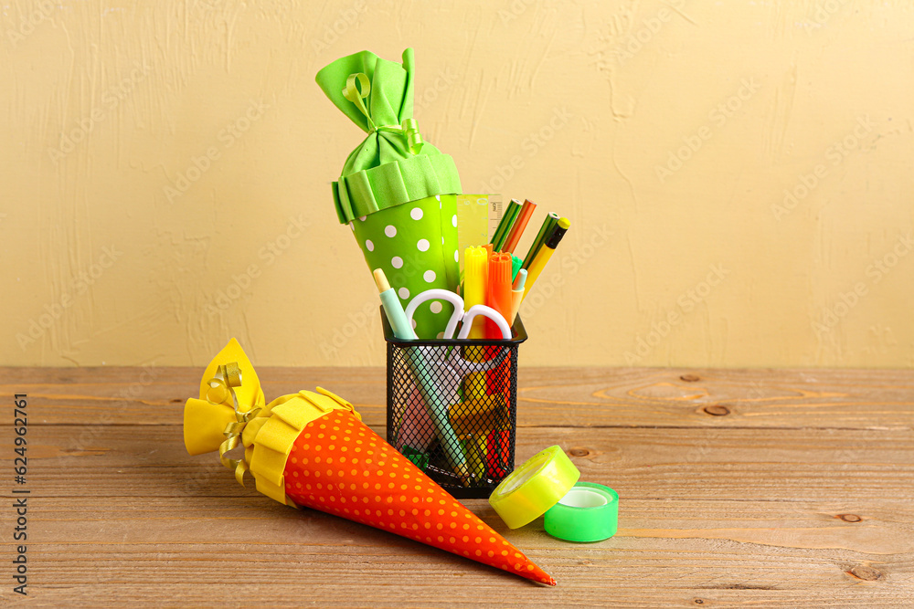 Colorful school cones and stationery on wooden table