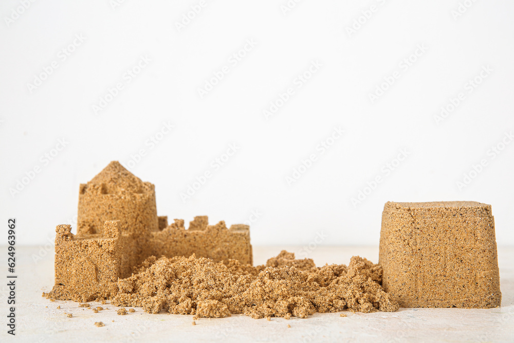 Castle made of sand on white background