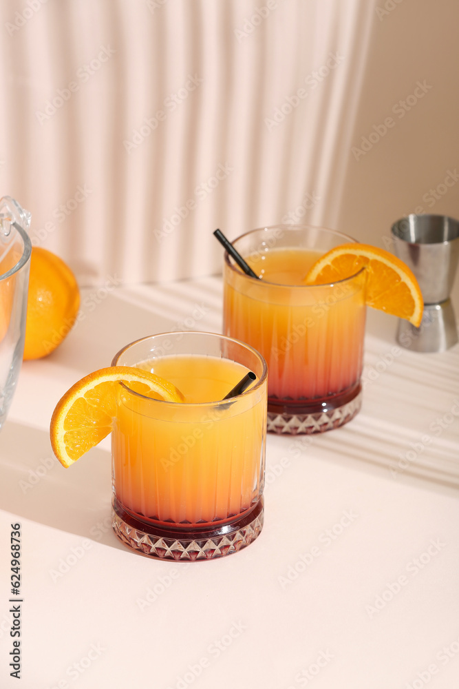 Glasses of tasty mai tai cocktail on light background