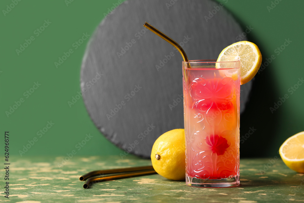 Glass of tasty mai tai cocktail on green background