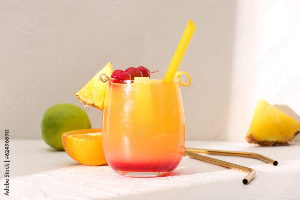 Glass of tasty mai tai cocktail on light background