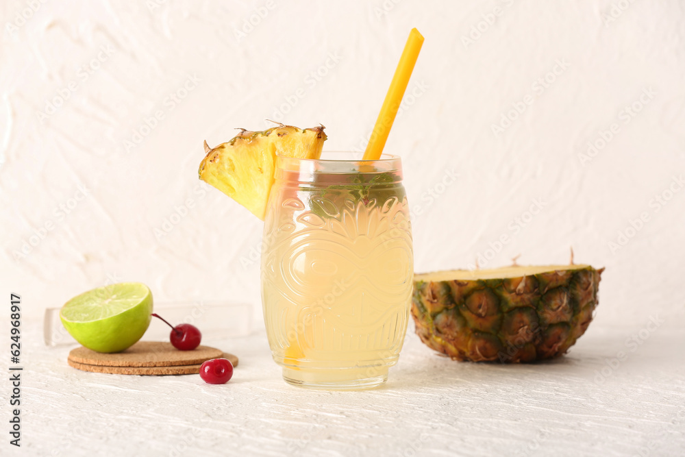 Glass of tasty mai tai cocktail on light background