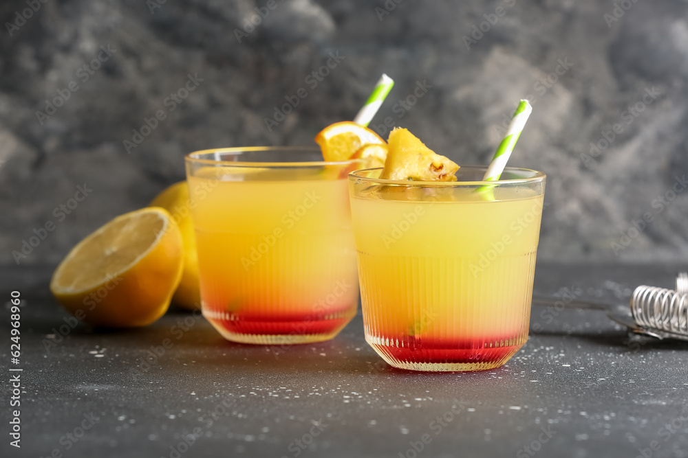 Glasses of tasty mai tai cocktail on black background