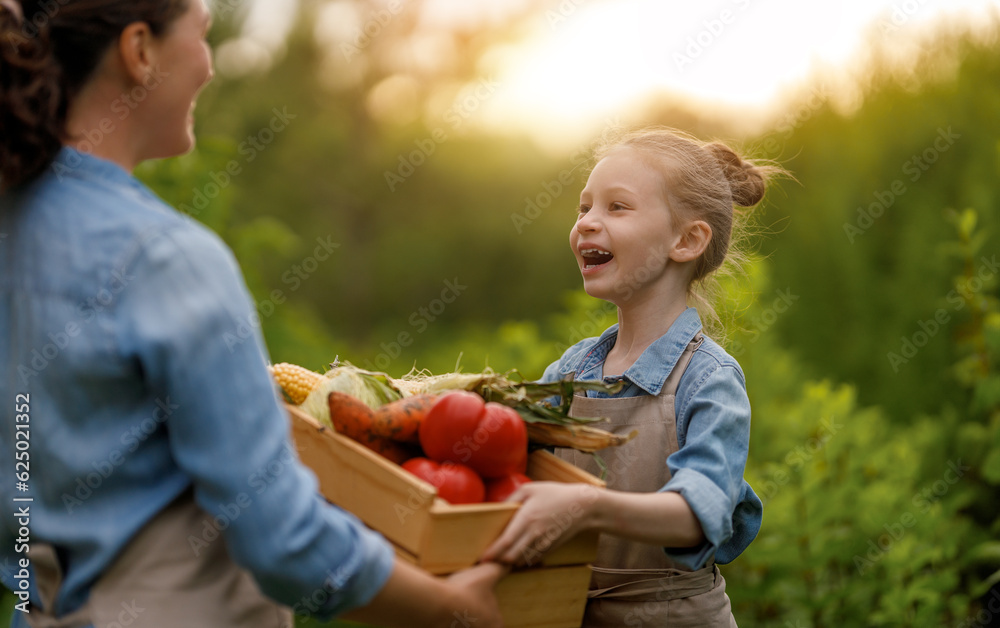 mother and daughter gardening in the backyard