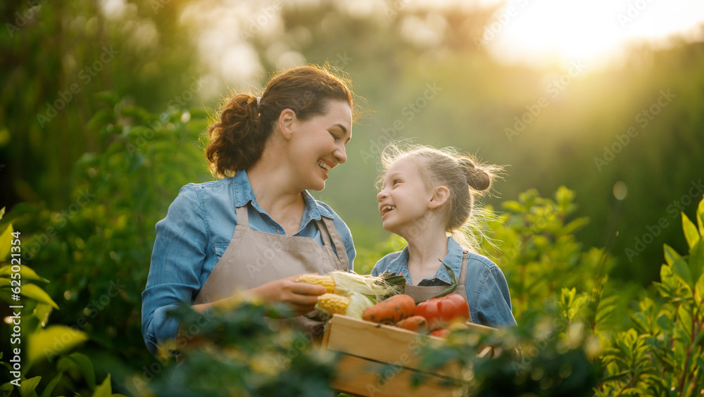 mother and daughter gardening in the backyard