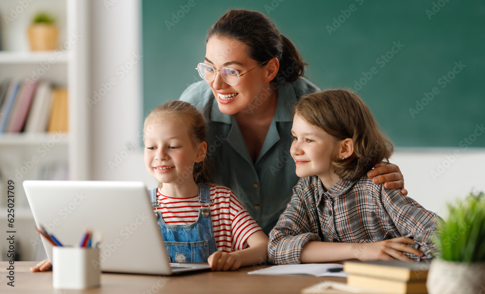 Happy kids and teacher at school