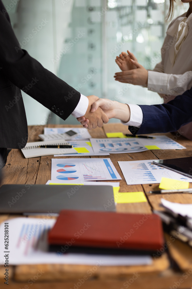 Business meeting, businesswomen shaking hands in business partnership meeting.