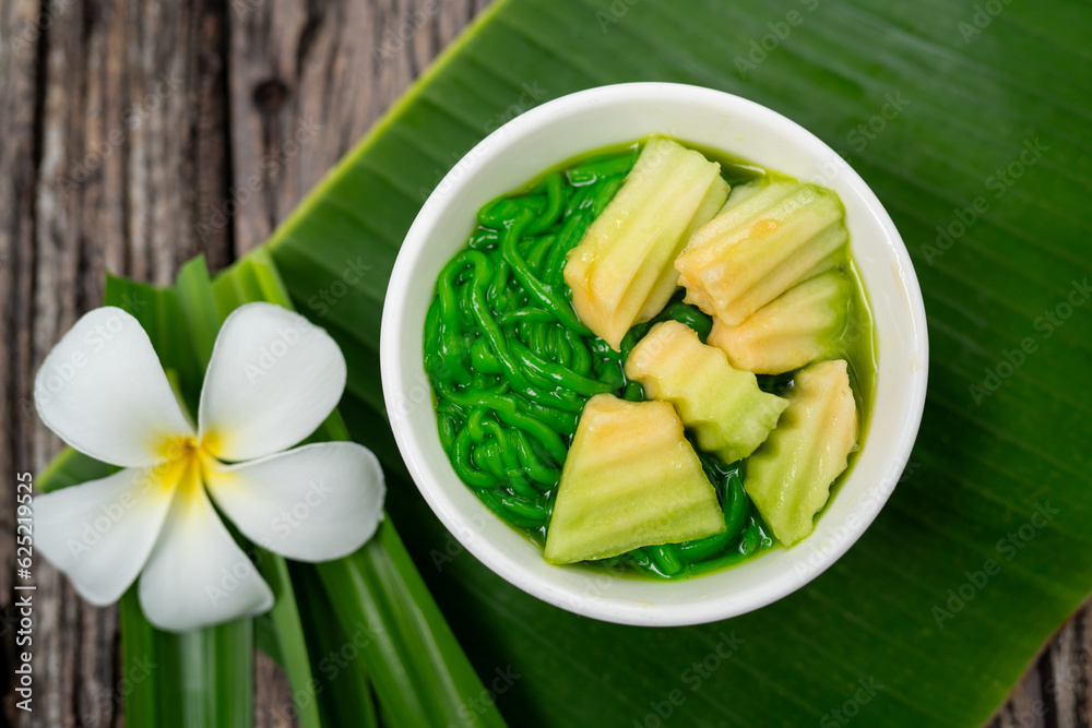 Lod Chong Thai dessert with pandan leaf on the wood background.