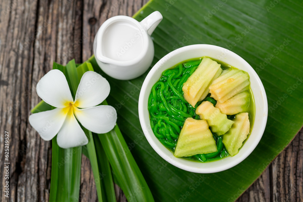 Top view of Lod Chong Thai dessert with pandan leaf on the wood background.