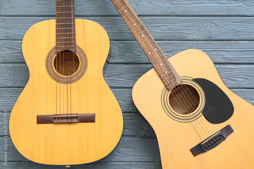 Acoustic guitars on wooden background, top view