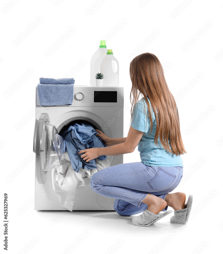 Woman putting dirty clothes into washing machine isolated on white background