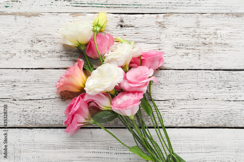 Beautiful pink eustoma flowers on white wooden background