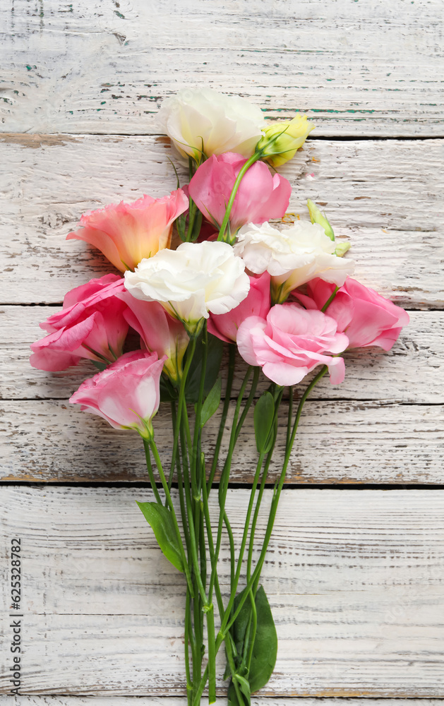 Beautiful pink eustoma flowers on white wooden background