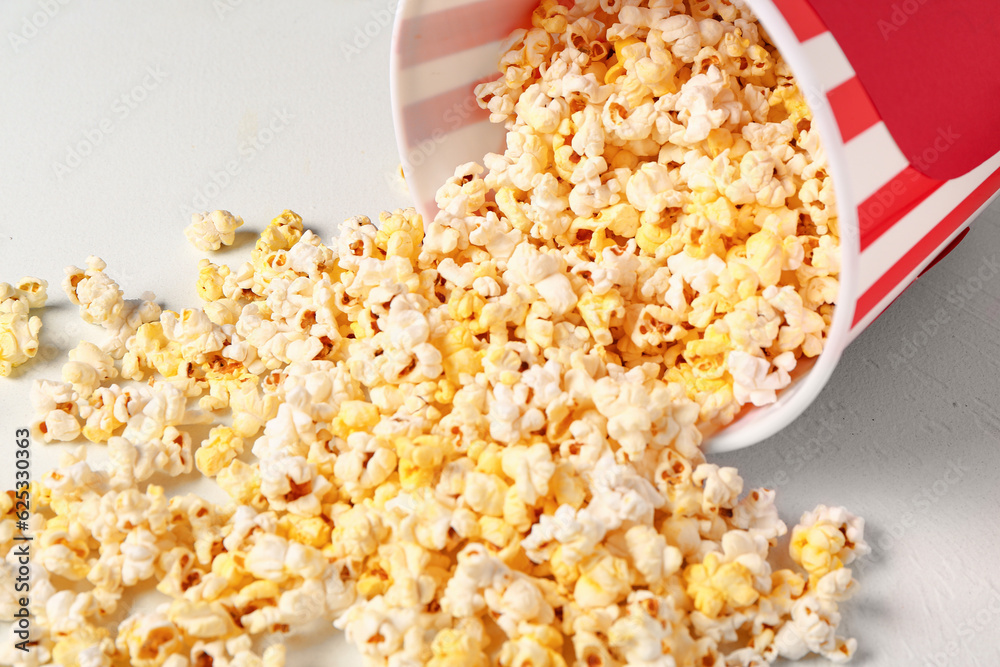 Bucket with tasty popcorn on white background