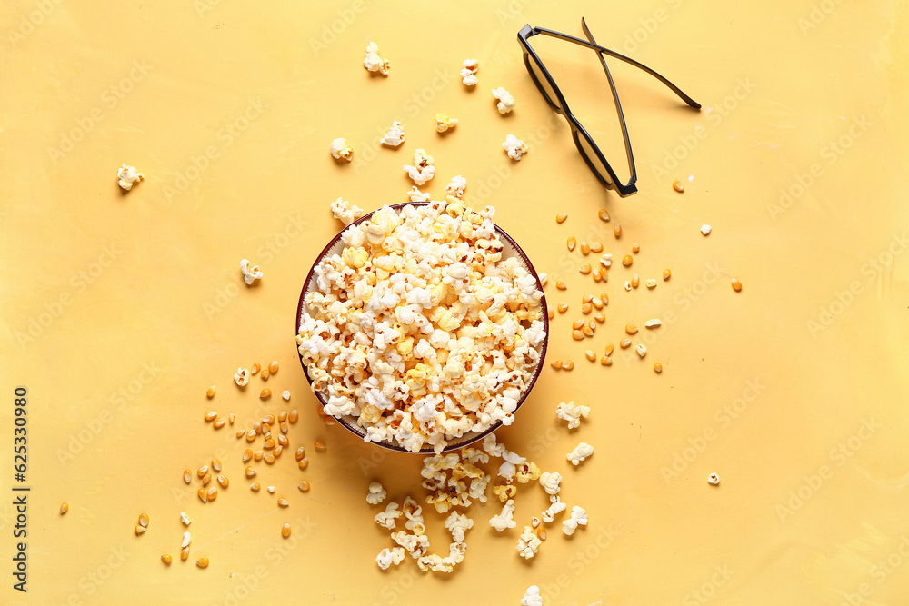 Bowl with tasty popcorn and 3D glasses on yellow background