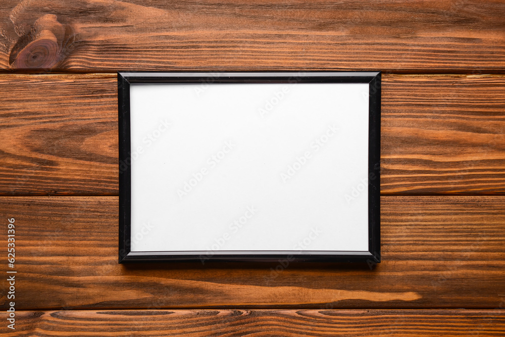 Blank photo frame on wooden background