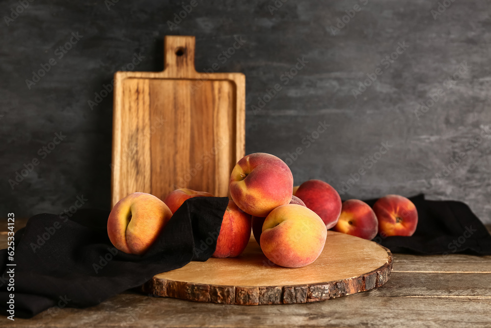 Board with sweet peaches on wooden table