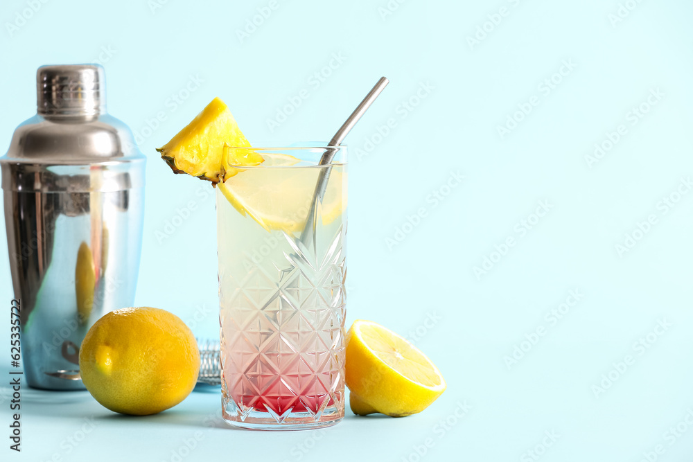 Glass of tasty mai tai cocktail on blue background