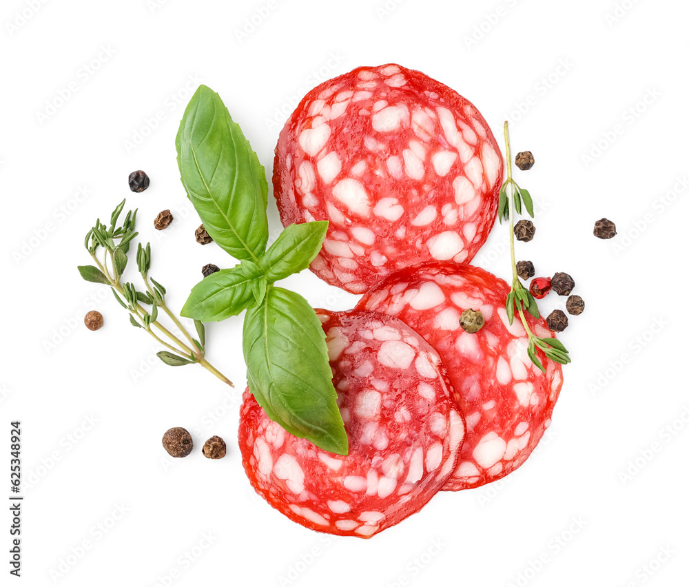 Slices of tasty salami with spices on white background