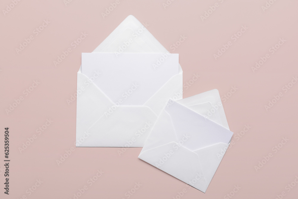 Paper envelopes with blank cards on color background