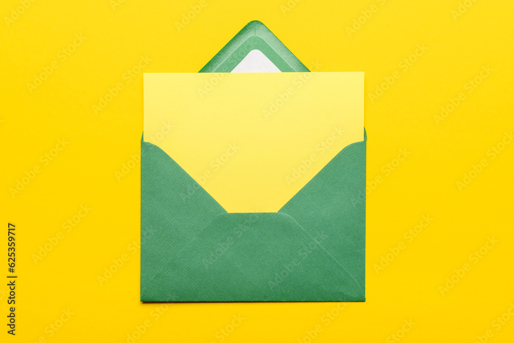 Paper envelope with blank card on yellow background