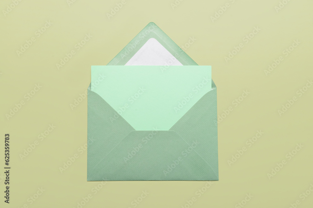 Paper envelope with blank card on color background