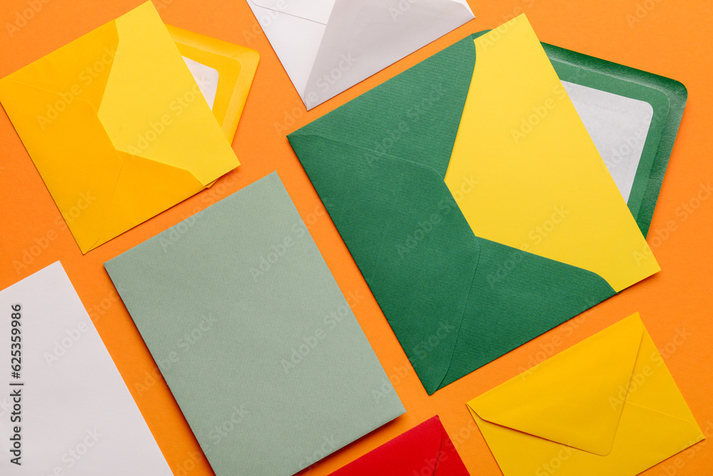 Set of different envelopes with blank cards on color background, closeup