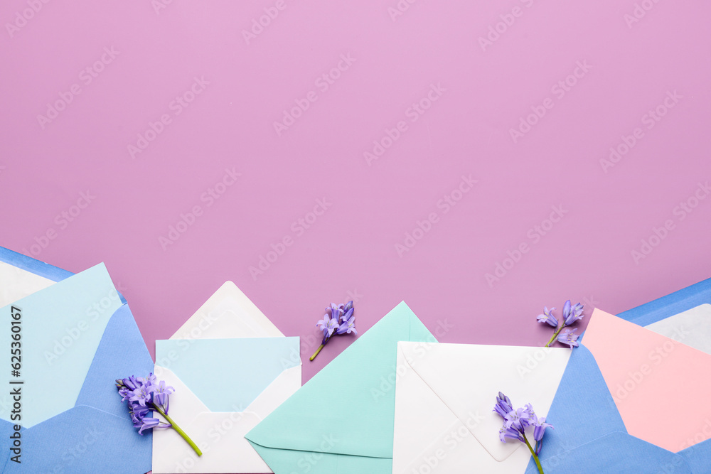 Composition with different paper envelopes, blank cards and flowers on color background