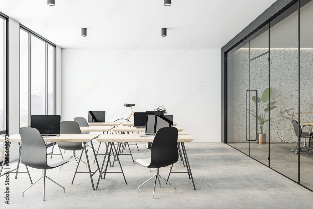 Modern coworking office interior design with light wooden tables, dark chairs, white wall background