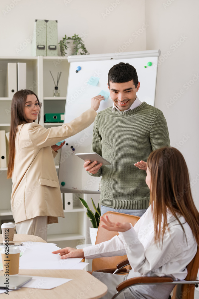 Colleagues working on business plan in office