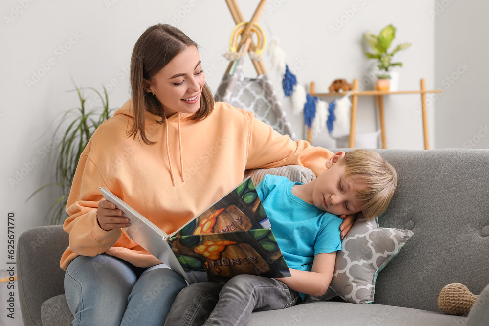 Nanny reading story to little boy at home