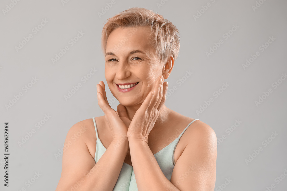 Mature woman with marked face for filler injection on light background