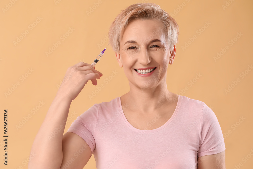 Mature woman with filler injection on beige background