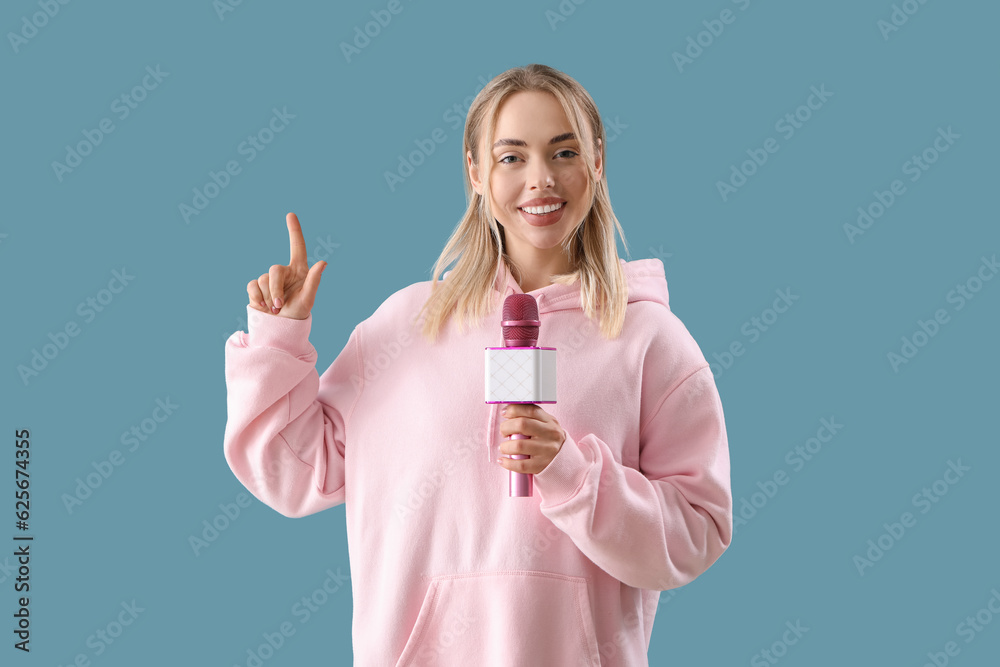 Female journalist with microphone pointing at something on blue background