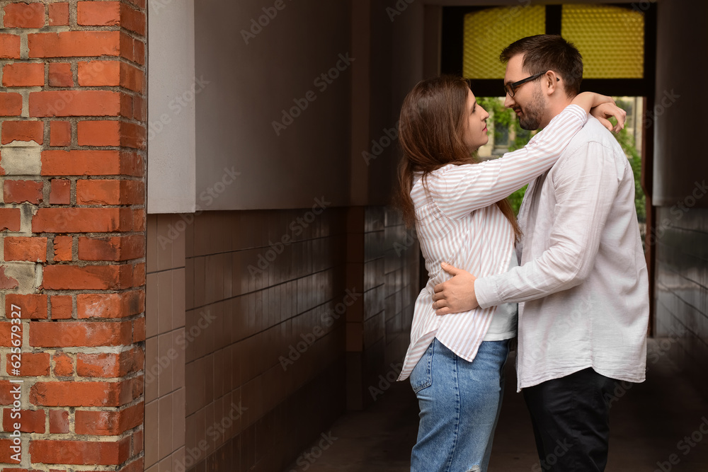 Beautiful loving couple hugging in city on spring day