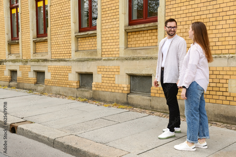 Beautiful loving happy couple walking in city on spring day