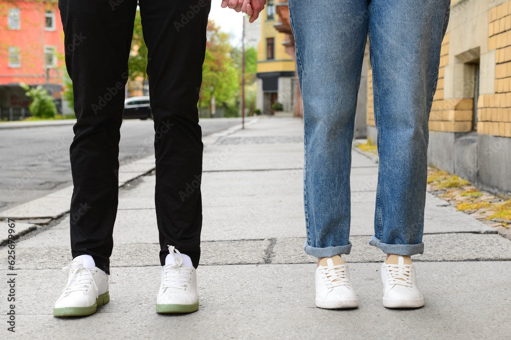 Beautiful loving couple walking in city on spring day