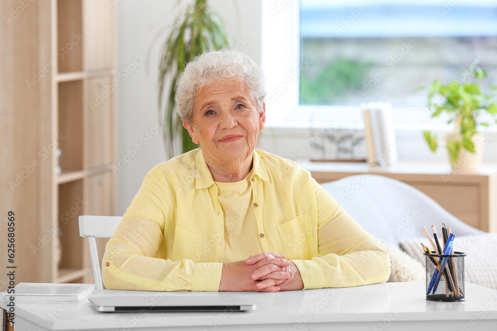 Senior woman sitting at home