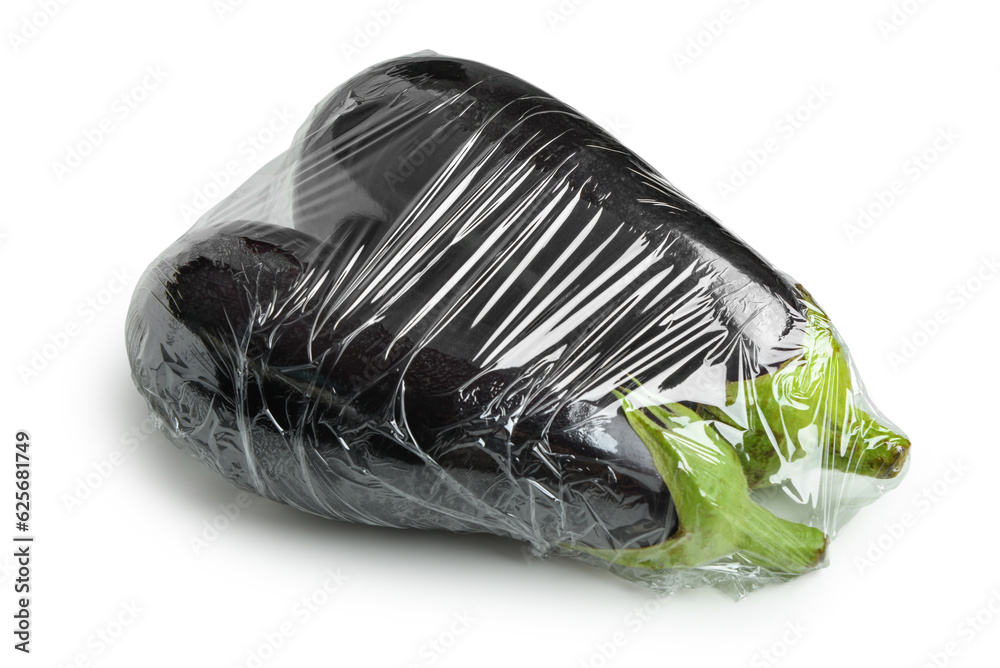 Fresh eggplant in plastic food wrap on white background