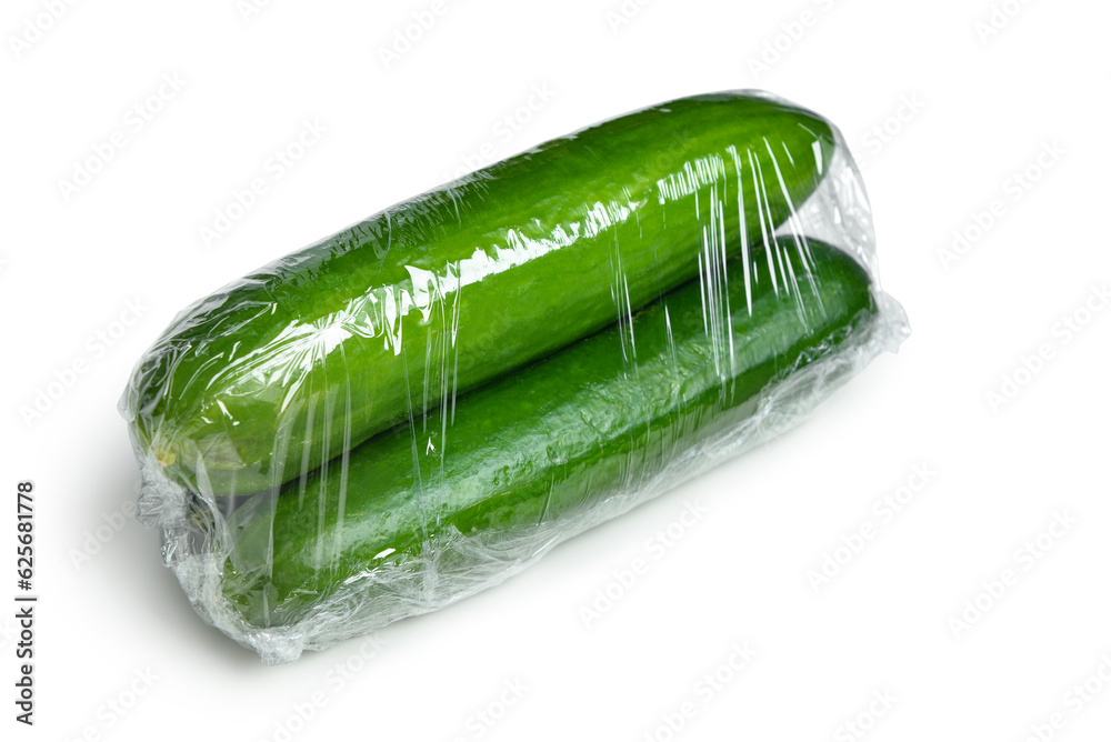 Cucumber in plastic food wrap on white background