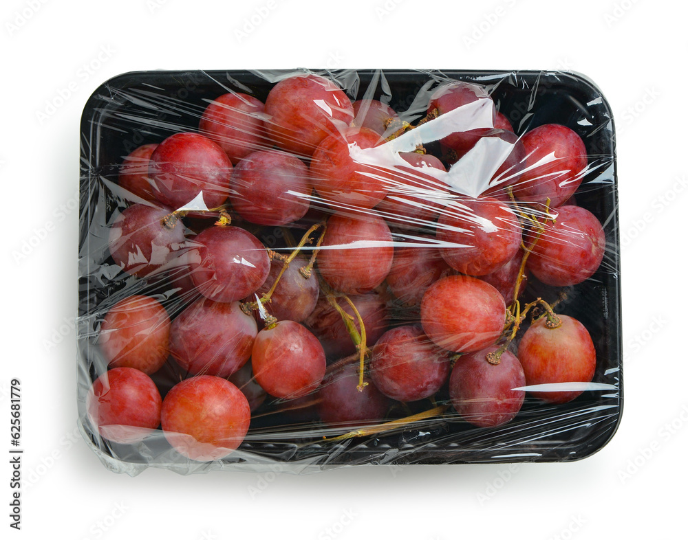 Plastic package with ripe red grapes on white background