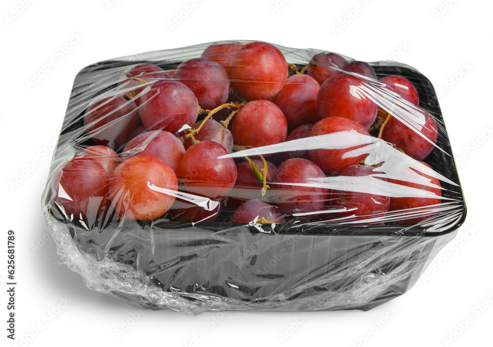 Plastic package with ripe red grapes on white background