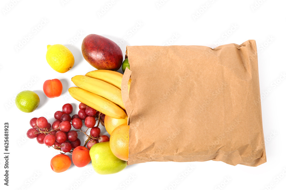 Paper bag with fresh fruits on white background. Grocery shopping concept