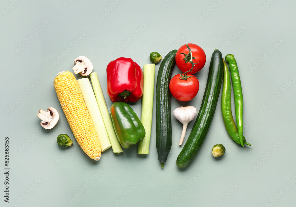 Different fresh vegetables on green background