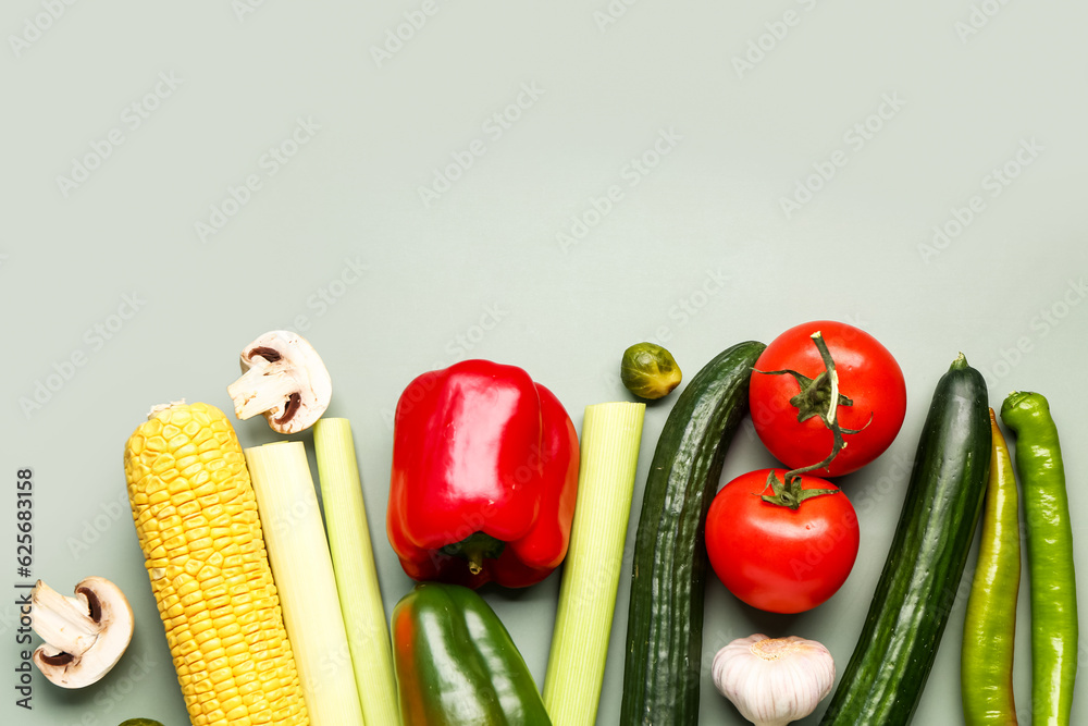 Different fresh vegetables on green background