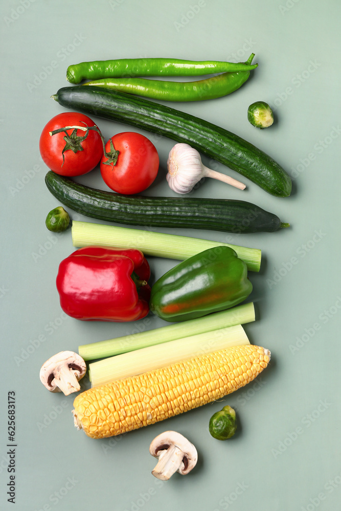 Different fresh vegetables on green background