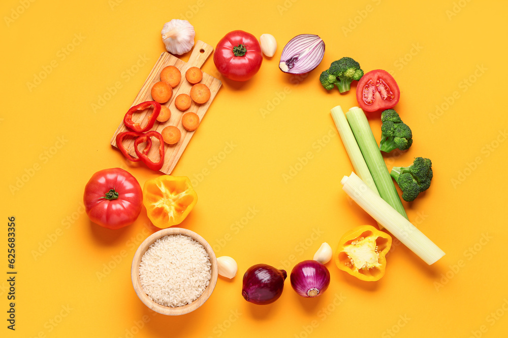 Frame made of different fresh vegetables on orange background