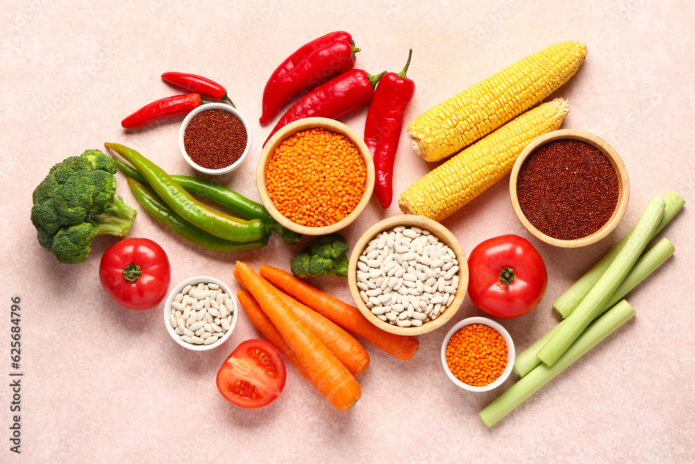 Different fresh vegetables and cereals on pink background