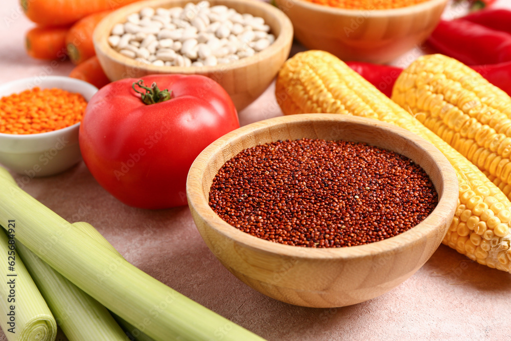 Different fresh vegetables and cereals on pink background, closeup